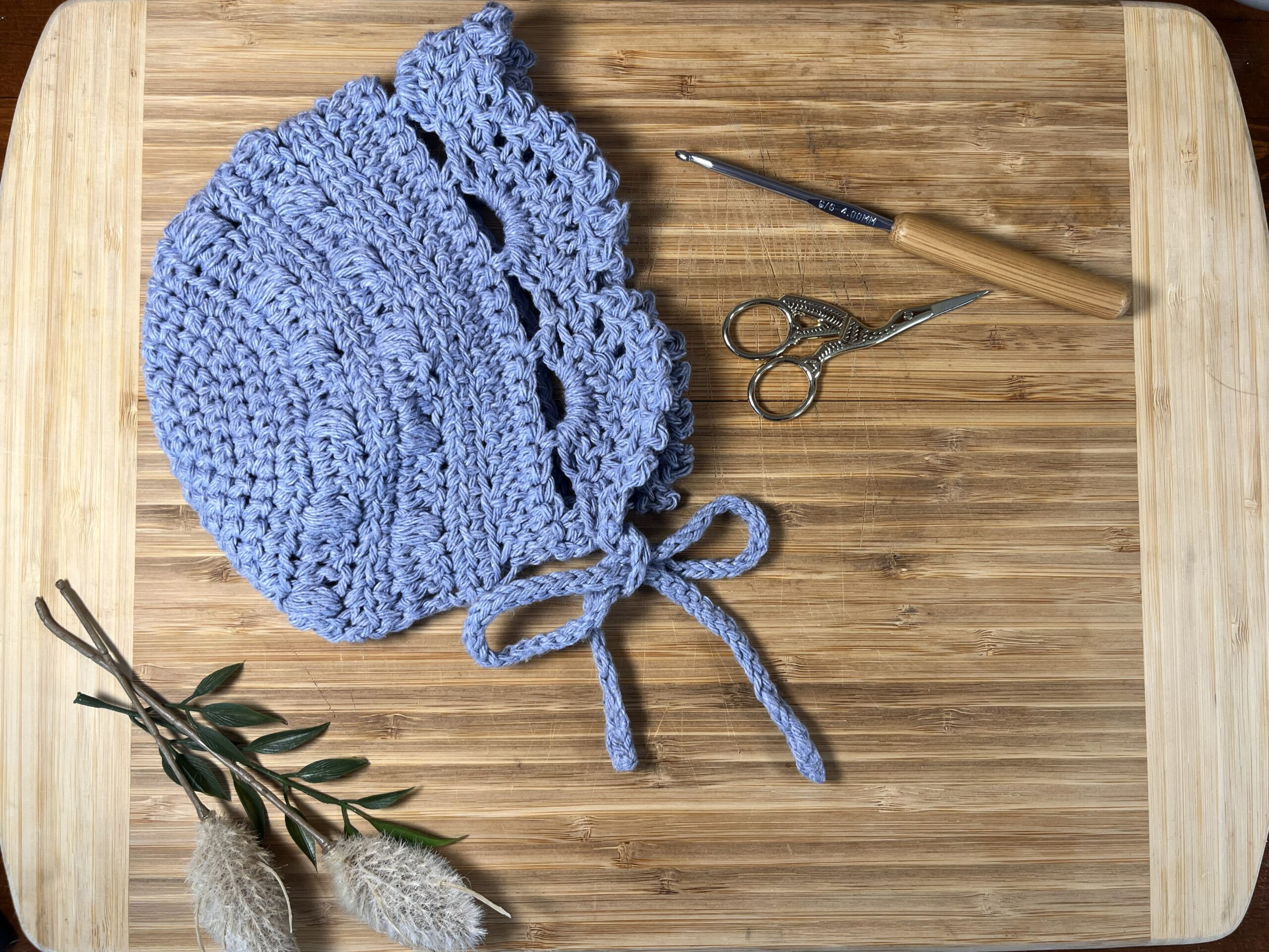 Simple Days Baby Bonnet Crochet Pattern Featured in blue.
