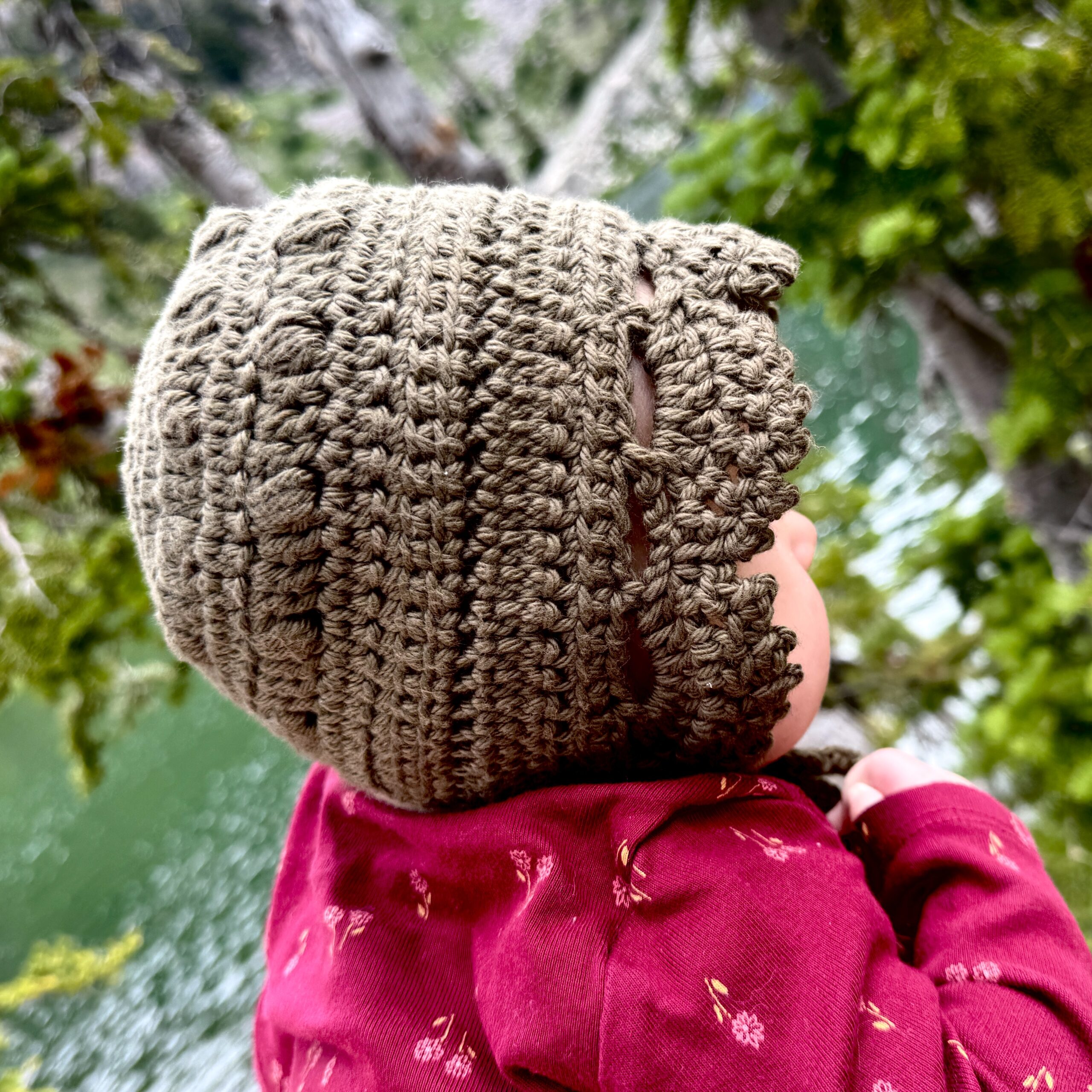 Simple Days Baby Bonnet Crochet Pattern Being worn by a little baby
